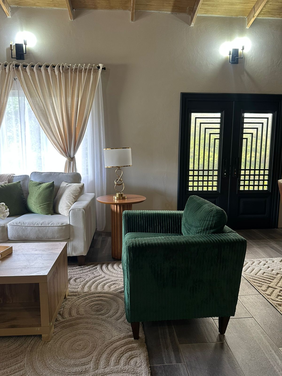 Emerald corduroy accent chair paired with soft neutrals and brass.