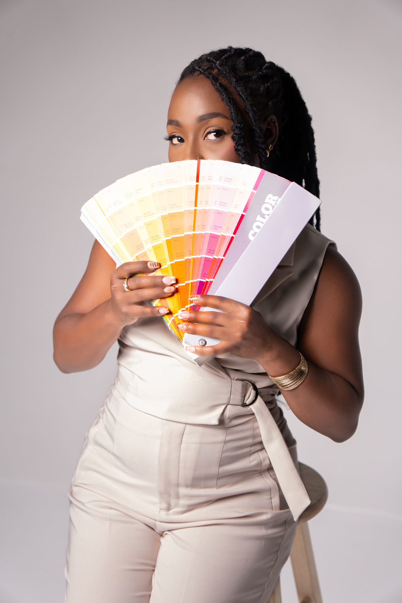 Designer holding a Sherwin-Williams color fan deck
