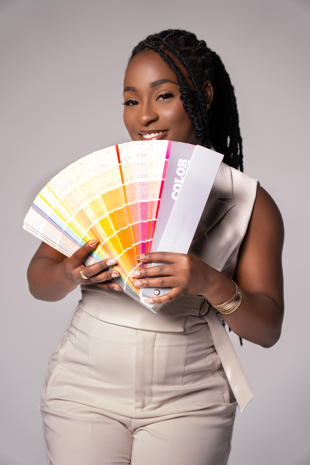Interior designer holding a Sherwin-Williams color fan deck